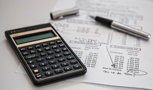 Stock photo of a calculator on top of a monthly expenditure report