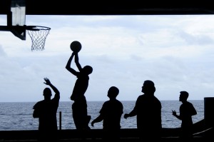 Stock photo of a group of silhouettes playing basketball