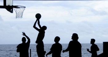 Stock photo of a group of silhouettes playing basketball