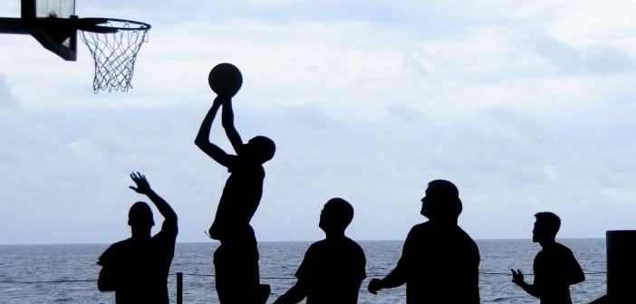 Stock photo of a group of silhouettes playing basketball