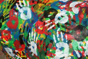 Stock photo of a mural of multi-colored hand prints