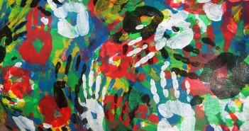 Stock photo of a mural of multi-colored hand prints
