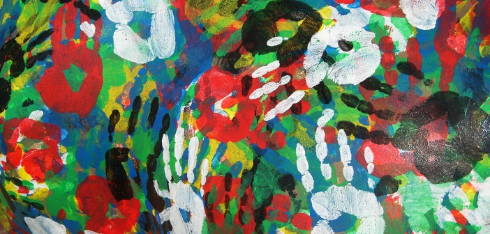 Stock photo of a mural of multi-colored hand prints