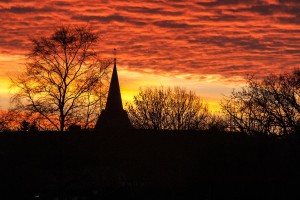 Stock photo of a silhouette of a church in a sunset