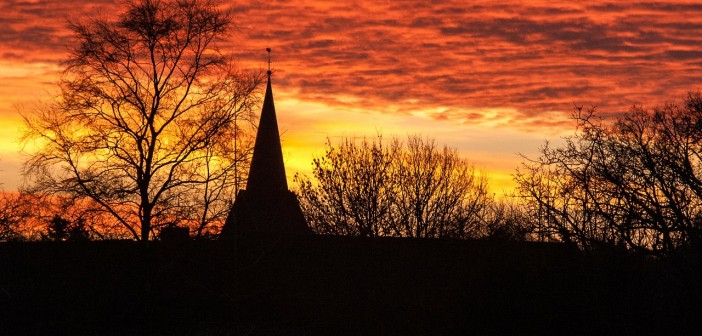 Stock photo of a silhouette of a church in a sunset