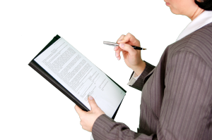 Stock photo of a businesswoman looking over a legal document