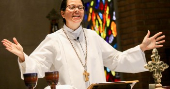 Stock photo of a woman presiding over communion