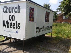 Stock image of a trailer that says "Church on Wheels"