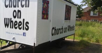 Stock image of a trailer that says "Church on Wheels"