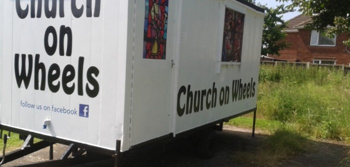 Stock image of a trailer that says "Church on Wheels"