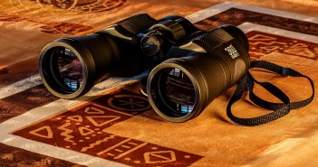 Stock photo of a pair of binoculars on a throw rug