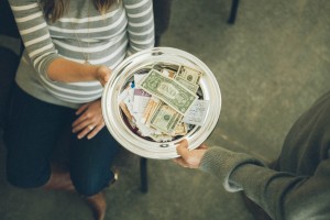 Stock photo of someone passing the collection plate