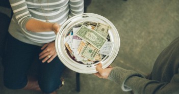 Stock photo of someone passing the collection plate