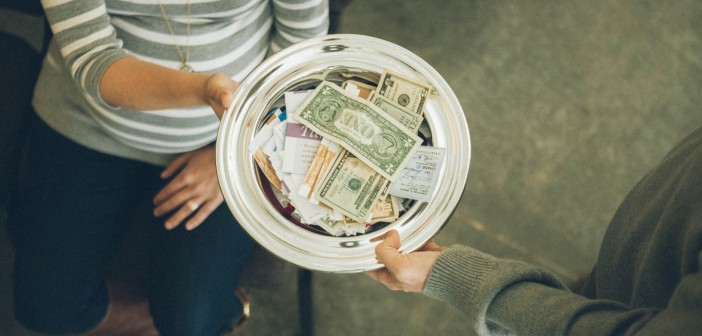 Stock photo of someone passing the collection plate