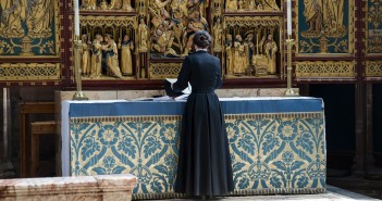 Stock photo of a clergywoman at an altar preparing for services