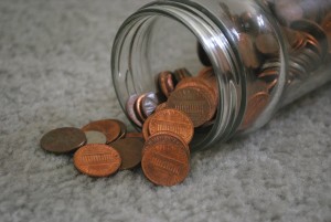 Stock photo of a jar of pennies on its side
