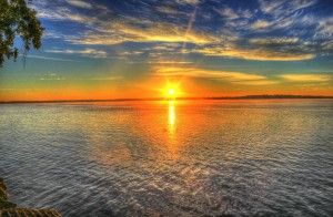 Stock photo of the sun rising or setting over a lake