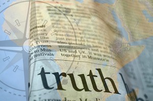 Collage of an atlas with a dictionary entry for "truth" overlain on top of it
