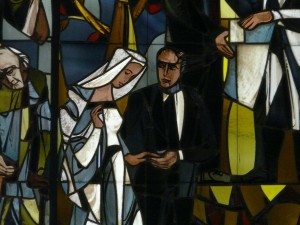 Stock photo of a stained glass window depiction of a man and a woman