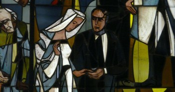 Stock photo of a stained glass window depiction of a man and a woman