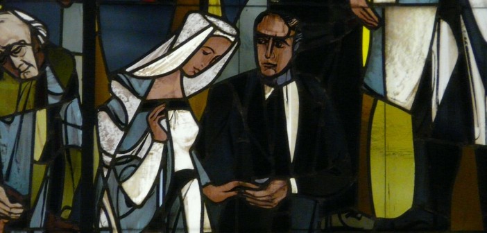 Stock photo of a stained glass window depiction of a man and a woman