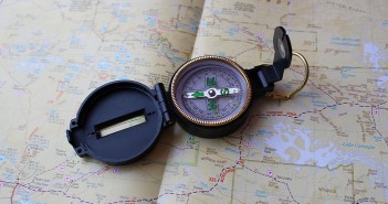 Stock photo of a field compass laying on top of a map