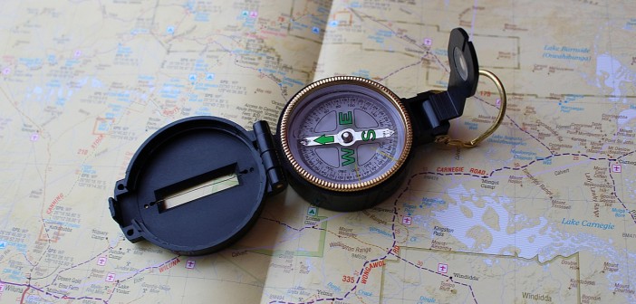 Stock photo of a field compass laying on top of a map