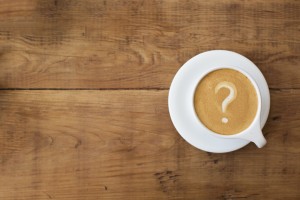 Stock photo of a latte in which the foam art is a question mark