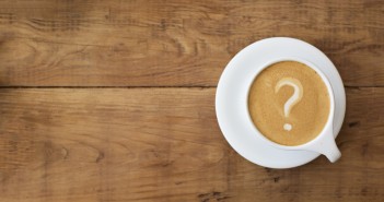 Stock photo of a latte in which the foam art is a question mark