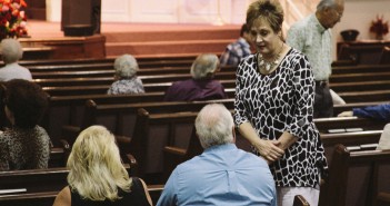 Stock photo of older white people talking to each other before church starts