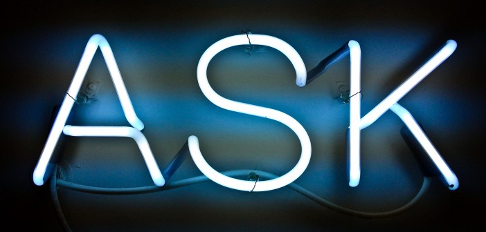 Stock photo of an illuminated neon sign that says "ASK"