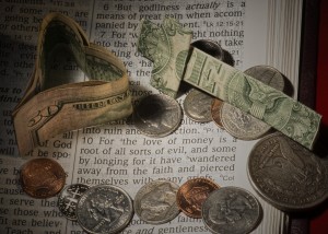 Photo of money lying atop a Bible