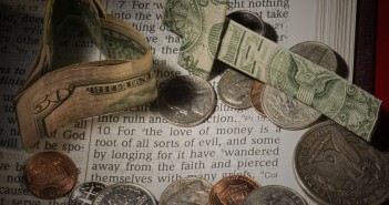 Photo of money lying atop a Bible