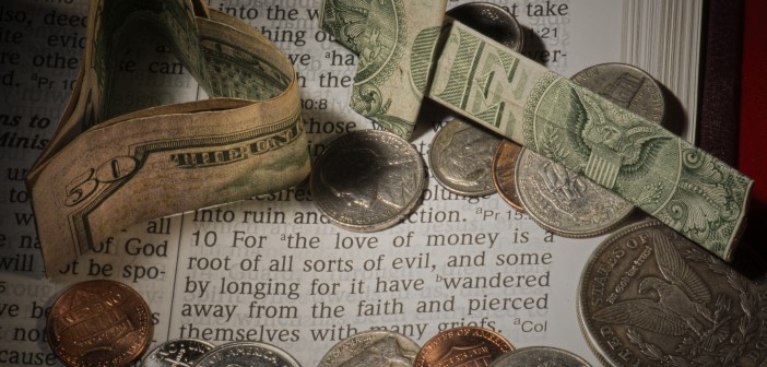 Photo of money lying atop a Bible