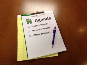 Stock photo of a church meeting agenda where participants will be discussing the "finance report," the "program report," and "other business"