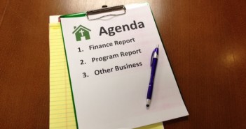 Stock photo of a church meeting agenda where participants will be discussing the "finance report," the "program report," and "other business"