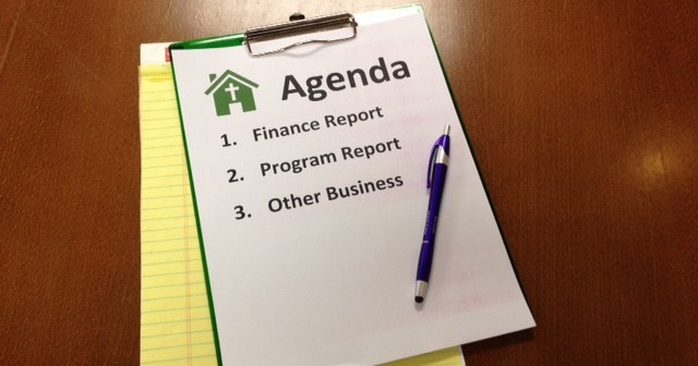 Stock photo of a church meeting agenda where participants will be discussing the "finance report," the "program report," and "other business"