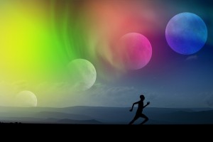 Stock photo of someone running along a beach with four moons and an aurora overhead