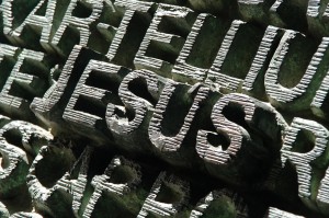 Stock photo of the word "JESUS" carved out of stone