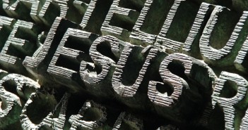 Stock photo of the word "JESUS" carved out of stone