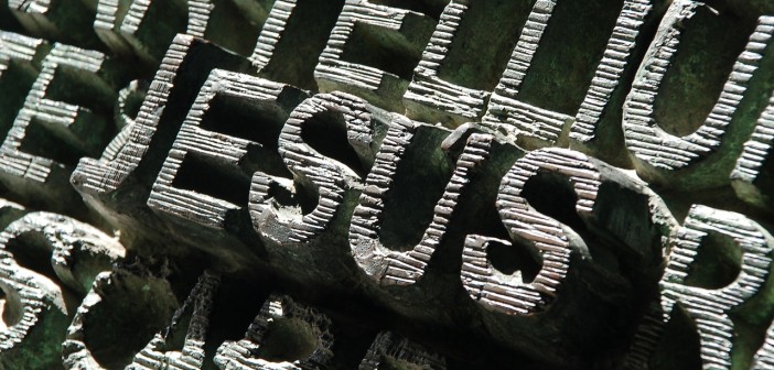 Stock photo of the word "JESUS" carved out of stone