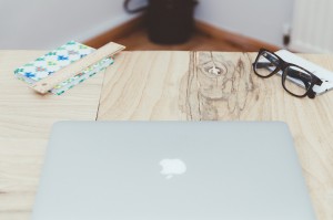 Stock photo of an Apple laptop on a wooden table
