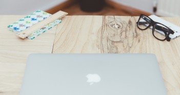 Stock photo of an Apple laptop on a wooden table