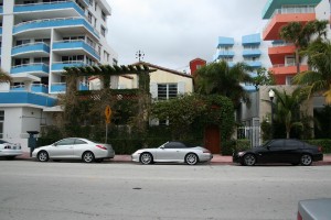 Stock photo of three cars parked outside of a building