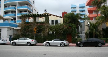 Stock photo of three cars parked outside of a building