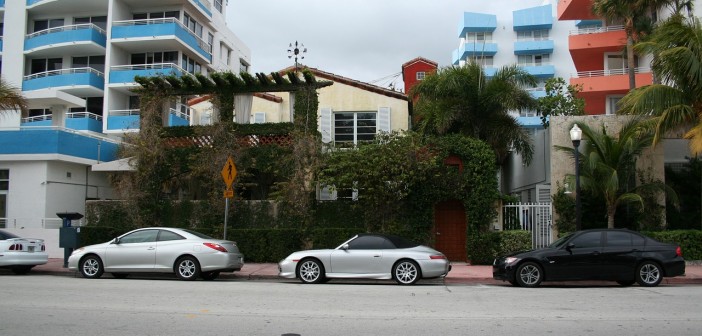 Stock photo of three cars parked outside of a building