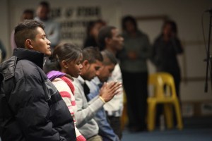 A stock photo of a diverse group of people praying