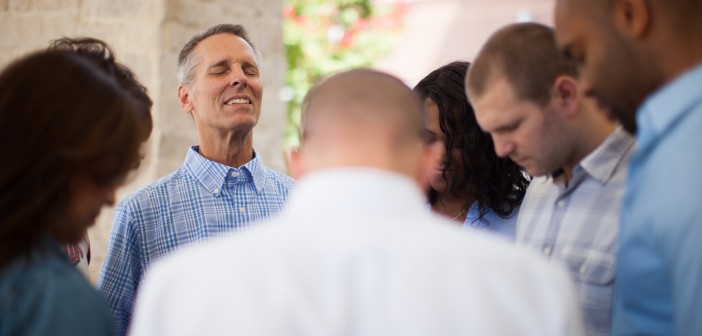 Stock photo of a diverse group of people praying