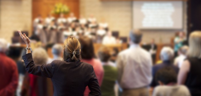 Stock photo of a group of people worshipping together