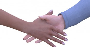 Stock photo of an African American hand and a white hand shaking hands
